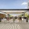 Outdoor roof deck terrace featuring  shaded pergolas, lounge seating, a granite bar counter and stools, and grilling stations