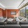 Grey sectional couch in The Brookliner's community lounge facing a tv, and overlooking the rooftop terrace