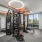 Fitness center featuring a boxing bag, free weights, gym ropes, and a view of the rooftop terrace.