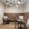 Co-working space at The Brookliner in Boston featuring leather bench seating, three tables, and additional chair seating.