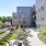 Roof deck terrace featuring lush greenery, a row of reclining lounge chairs, a fire pit with Adirondack chair seating and various couches