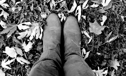 lifestyle image of a woman's boots standing in leaves